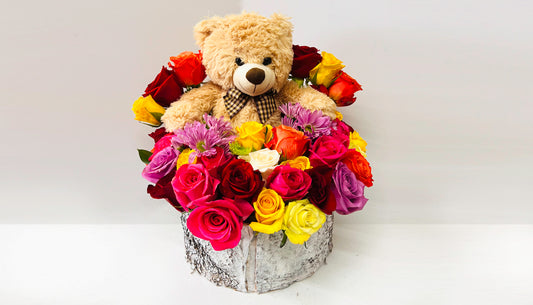 Bed of roses with teddy bear